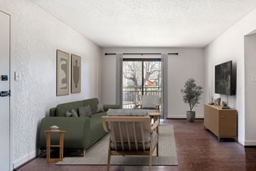 Kansas City apartment for rent - A living room with a green couch and a wooden table.
