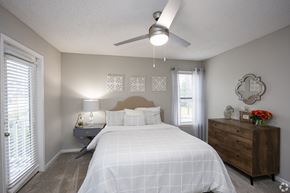 Doraville apartment for rent - A bedroom with a bed, nightstand, and a dresser.