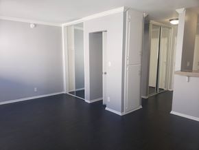 Los Angeles apartment for rent - A room with a white door and a mirror on the wall.