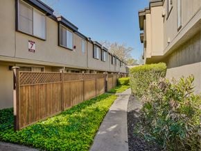 Santa Rosa apartment for rent - a long wooden fence separates the two buildings of an apartment complex