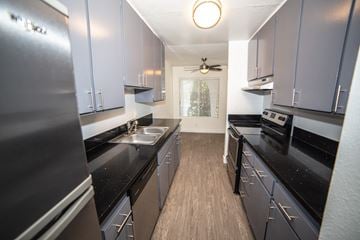Camarillo apartment for rent - a kitchen with black counters and stainless steel appliances