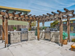 Rohnert Park apartment for rent - an outdoor kitchen with two stoves and a pergola