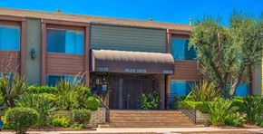 Encino apartment for rent - a brown building with a tan awning and stairs in front of it