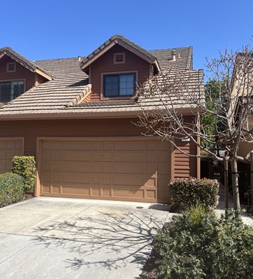 San Jose apartment for rent - A brown house with a tan garage door.