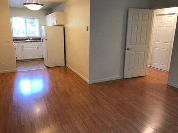 San Jose apartment for rent - an empty kitchen with a refrigerator and a door