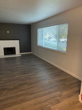 Sunnyvale apartment for rent - an empty living room with a fireplace and a window