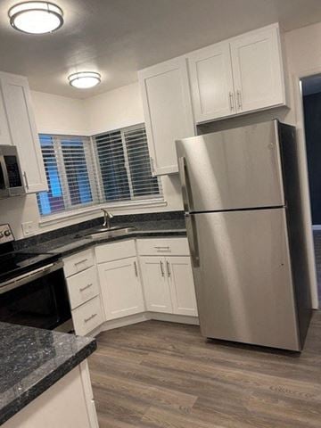 Sunnyvale apartment for rent - a kitchen with white cabinets and a stainless steel refrigerator