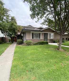 San Jose condo for rent - a house with a sidewalk and trees in front of it