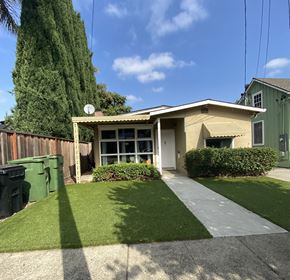 Santa Clara apartment for rent - a small tan house with a driveway and a green fence