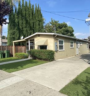 Santa Clara apartment for rent - a small yellow house with a driveway and a yard