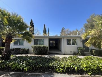 Cupertino apartment for rent - A house with a white exterior and a green lawn in front.