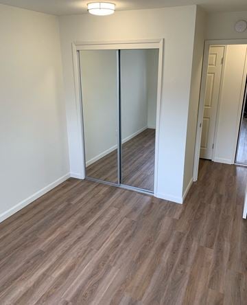 San Mateo apartment for rent - a living room with wood flooring and a mirrored closet