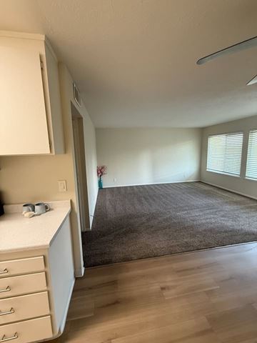 San Jose apartment for rent - A kitchen with white cabinets and a countertop with a few items on it.