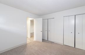 Santa Cruz apartment for rent - a bedroom with white walls and white closets and carpeting