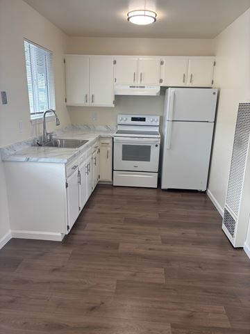 South San Francisco apartment for rent - A kitchen with white appliances and wooden floors.