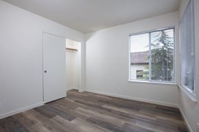 Santa Cruz apartment for rent - a bedroom with a large window and wood floors