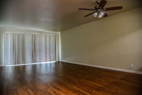 San Jose apartment for rent - an empty living room with a ceiling fan and blinds