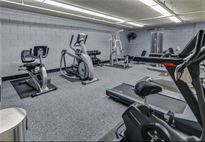 San Bruno apartment for rent - a gym with cardio equipment and weights in a building