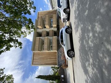 Redwood City apartment for rent - a view of a building from above with a car on the street