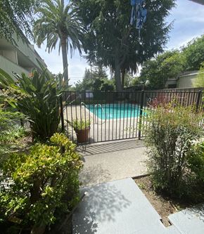 East Palo Alto apartment for rent - a pool in a backyard with a black fence