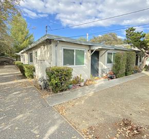 Cupertino apartment for rent - a small gray house with green shutters and a driveway