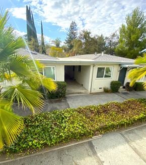 Cupertino apartment for rent - a white house with a driveway and a palm tree