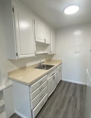 San Jose apartment for rent - an empty kitchen with white cabinets and a sink