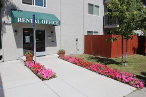 San Jose apartment for rent - The front entrance of the Aegena apts, the entrance to the office lined with pink flowers and a green banner Prodesse Property Group 1211 Garbo Way  San Jose, CA 95117
