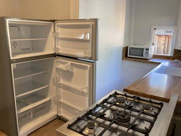 Santa Clara apartment for rent - A white refrigerator with its door open in a kitchen.