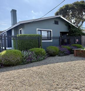 Monterey apartment for rent - A house with a grey roof and a black fence.