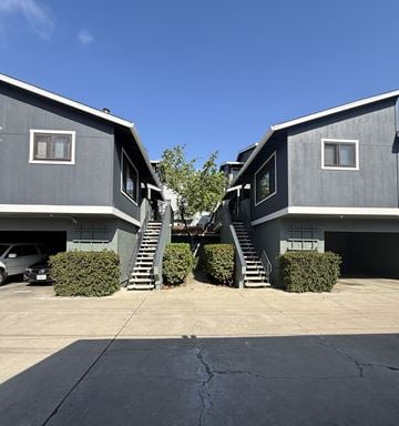 Monterey apartment for rent - Two houses with grey exteriors and staircases leading to the second floor.