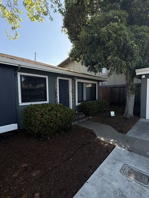 Monterey apartment for rent - A small house with a grey roof and a white door.