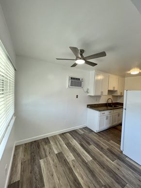 Campbell apartment for rent - an empty kitchen with white cabinets and a ceiling fan