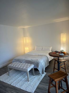 East Palo Alto apartment for rent - a bedroom with a bed and a table with a stool
