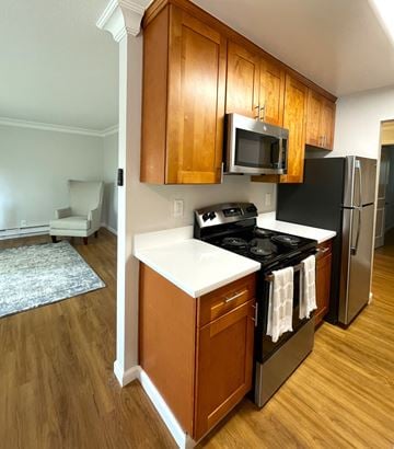 Campbell apartment for rent - a kitchen with stainless steel appliances and wooden cabinets
