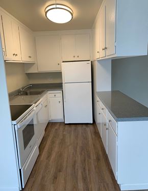 San Mateo apartment for rent - a kitchen with white cabinets and a white refrigerator