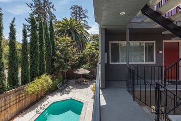 San Jose apartment for rent - a backyard with a pool and a patio with a table and chairs