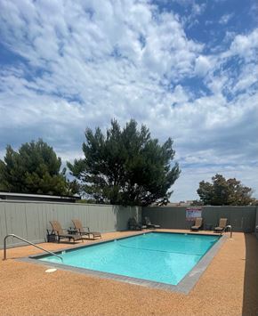 San Mateo apartment for rent - a swimming pool on a cloudy day in a backyard with chairs