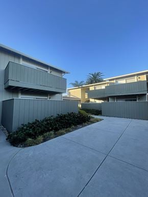 Sunnyvale apartment for rent - A modern building with a grey exterior and a clear blue sky in the background.