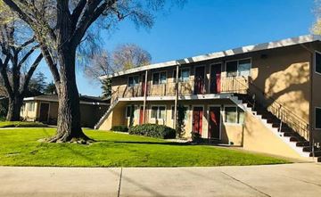 Campbell apartment for rent - a building with stairs and a tree in front of it