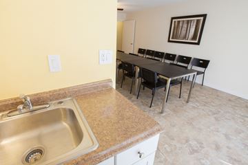 San Mateo apartment for rent - a kitchen with a sink and a table with chairs
