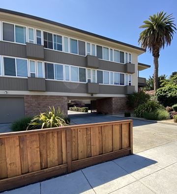 San Mateo apartment for rent - a wooden fence in front of an apartment building