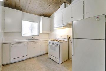 Mountain View apartment for rent - a kitchen with white appliances and white cabinets