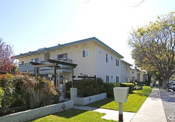 San Jose apartment for rent - A white house with a blue roof and a mailbox on the sidewalk.