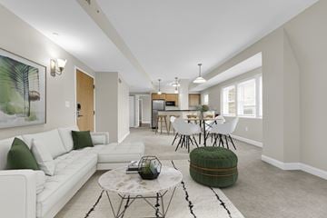 Cleveland apartment for rent - A living room with a white couch and a green ottoman.
