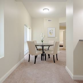 Cleveland apartment for rent - Dining room area of an apartment, furnished with a dining table, rug, carpet flooring, and a high ceiling.