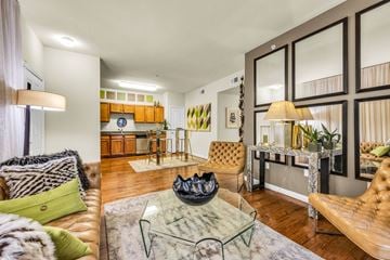 Austin apartment for rent - A living room with a brown leather couch and a glass coffee table.