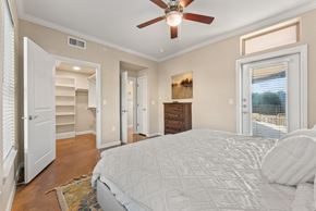 Austin apartment for rent - A bedroom with a large bed and a ceiling fan. at Bridge at Heritage Woods, Texas, 78753