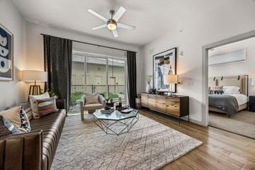 Austin apartment for rent - A modern living room with a brown leather couch and a glass coffee table.