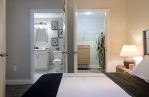 Canton apartment for rent - a bedroom with a large bed and a bathroom in the background
